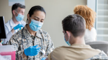 Mature soldier is military doctor giving COVID 19 vaccine injections