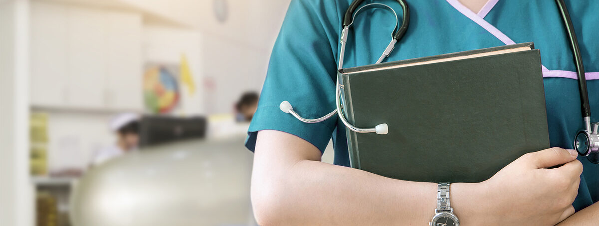 Cropped image of nurse holding green book on white background