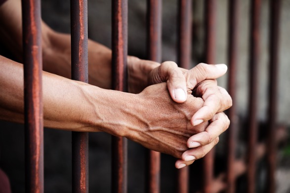 hands of prisoner in jail background picture id936426852