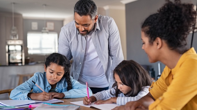 mixed race parents helping children in homework at home picture id1270069171