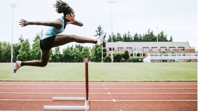 woman athlete runs hurdles for track and field picture id993744768