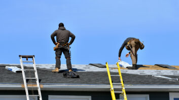 Two Men Roofing a House in the Sunshine